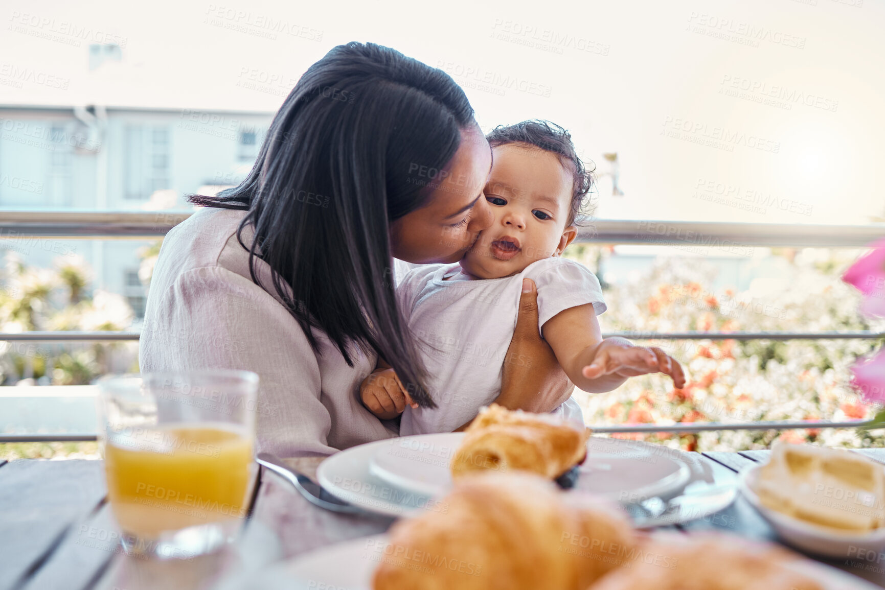 Buy stock photo Kiss, mom and baby at table for breakfast with smile, eating and morning bonding together on balcony. Embrace, mother and child with food, love and happy family in home for weekend brunch on patio