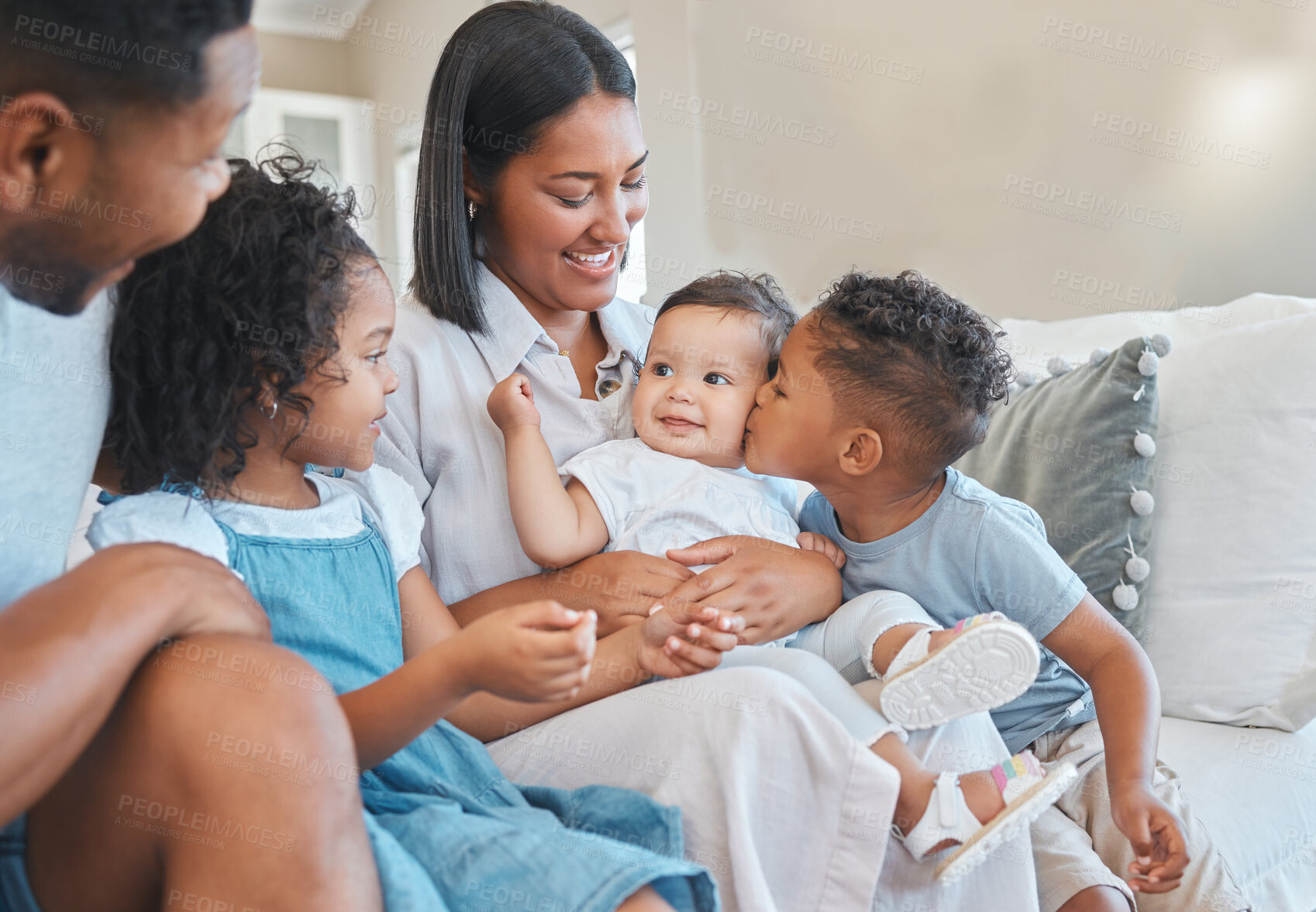 Buy stock photo Kiss, baby or children siblings with happy family on couch in house to relax with security, safety or care. Smile, boy or proud parents on sofa with kid, support and love for bonding together in home