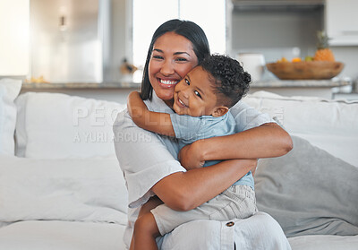 Buy stock photo Shot of a young woman being affectionate with her son on the sofa