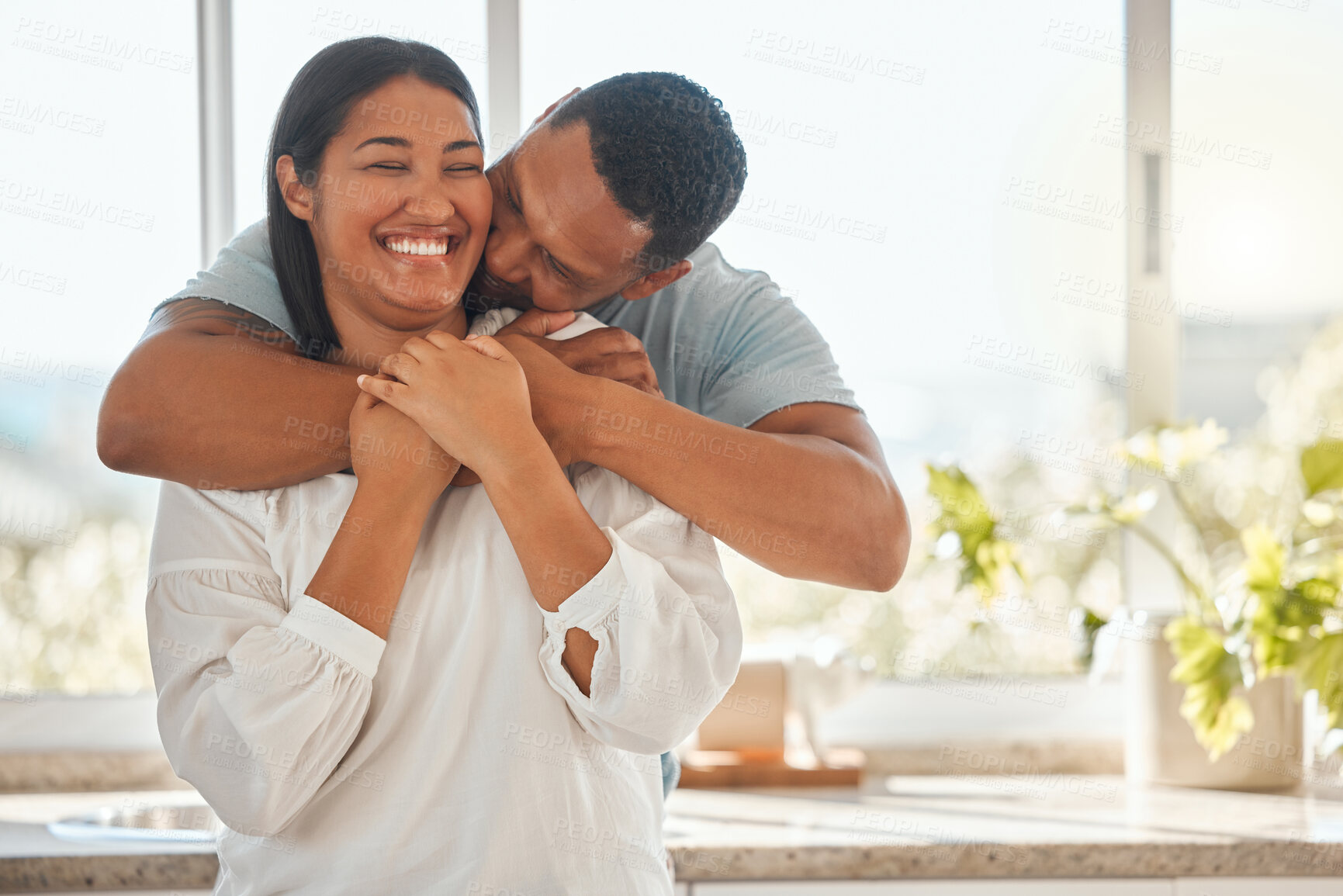 Buy stock photo Kitchen, couple and happy with hug for love with bonding, support and care. People, relationship and home with laughing or smile for funny conversation, affection and trust for break and relax