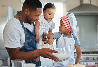 Buy stock photo Shot of a father baking at home with his two daughters