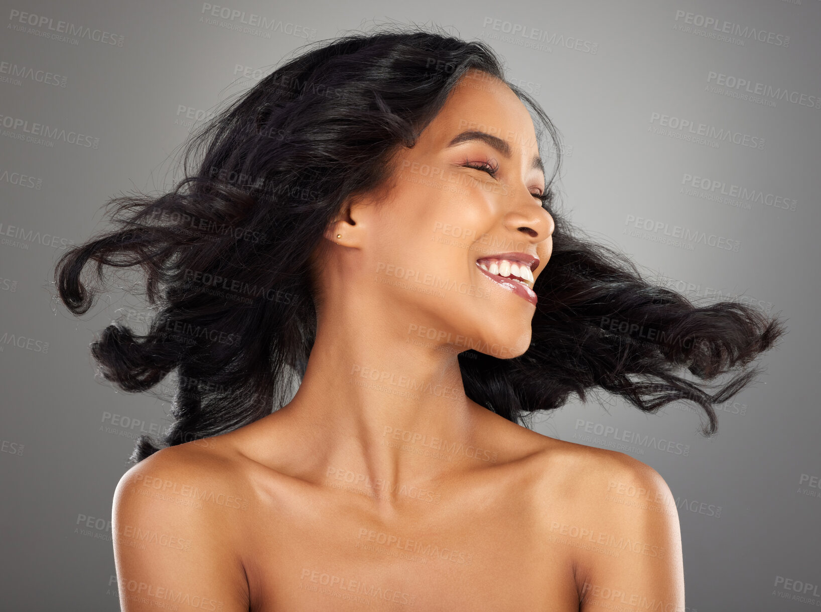 Buy stock photo Happy, hair and woman in studio shake for confidence, healthy texture and growth. Salon aesthetic, hairdresser and isolated person with smile for beauty, wellness and cosmetics on gray background