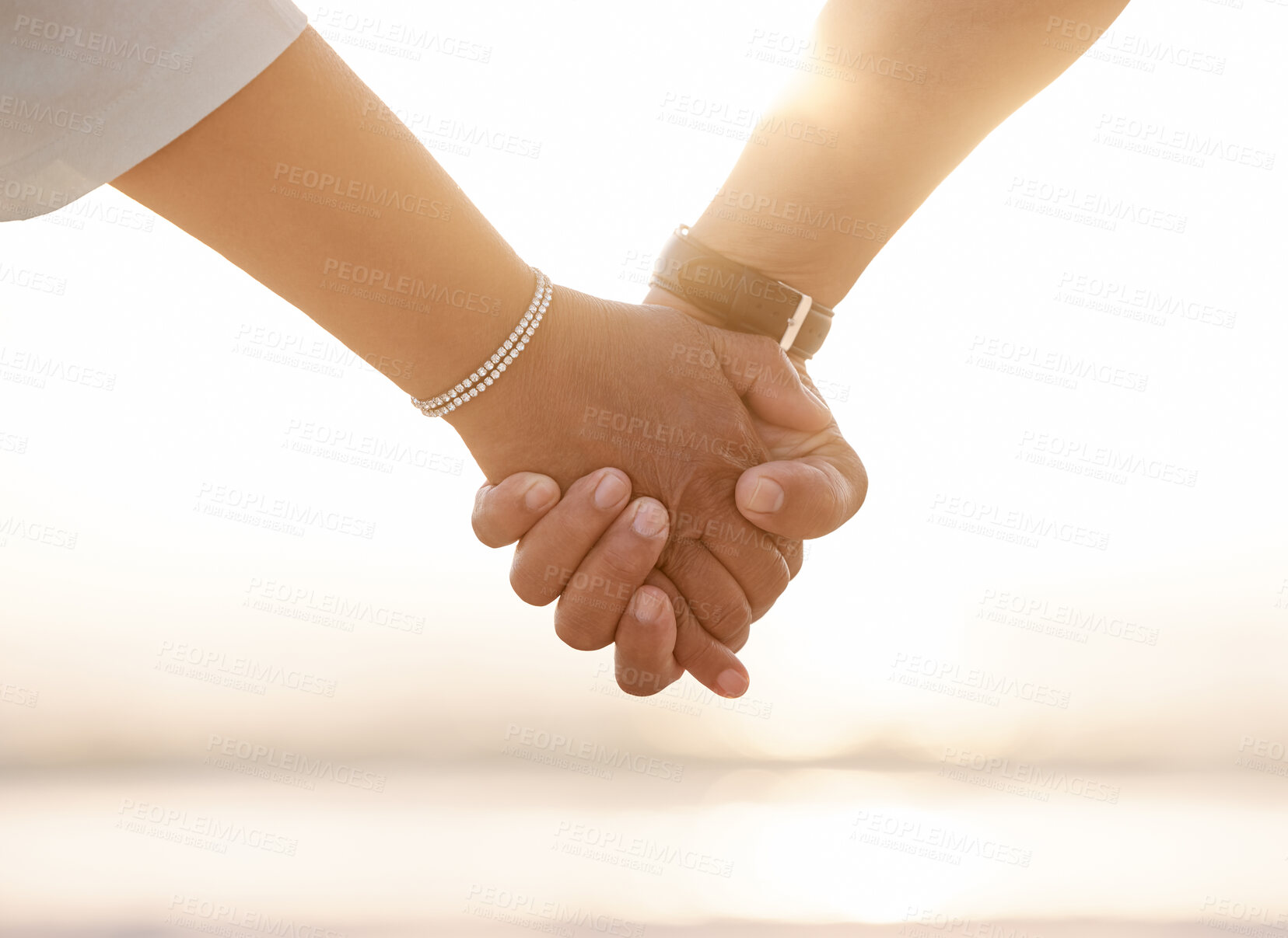 Buy stock photo Cropped shot of an unrecognizable couple holding hands on the beach