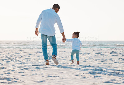 Buy stock photo Shot of a man spending the day at the beach with his daughter