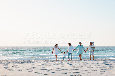 Buy stock photo Shot of a multi-generational family spending time together at the beach