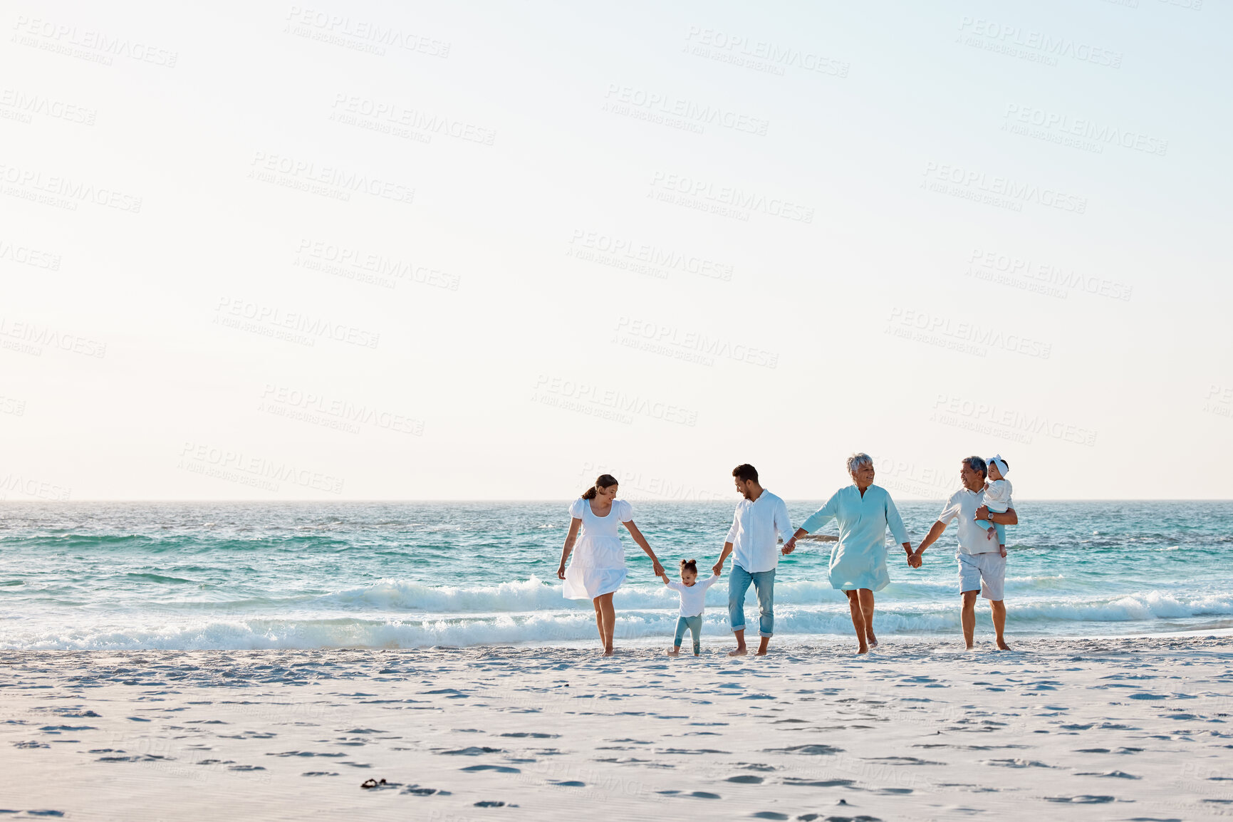 Buy stock photo Big family, holding hands and walking on beach with mockup space for holiday weekend or vacation. Grandparents, parents and kids on a ocean walk together for fun bonding or quality time in nature