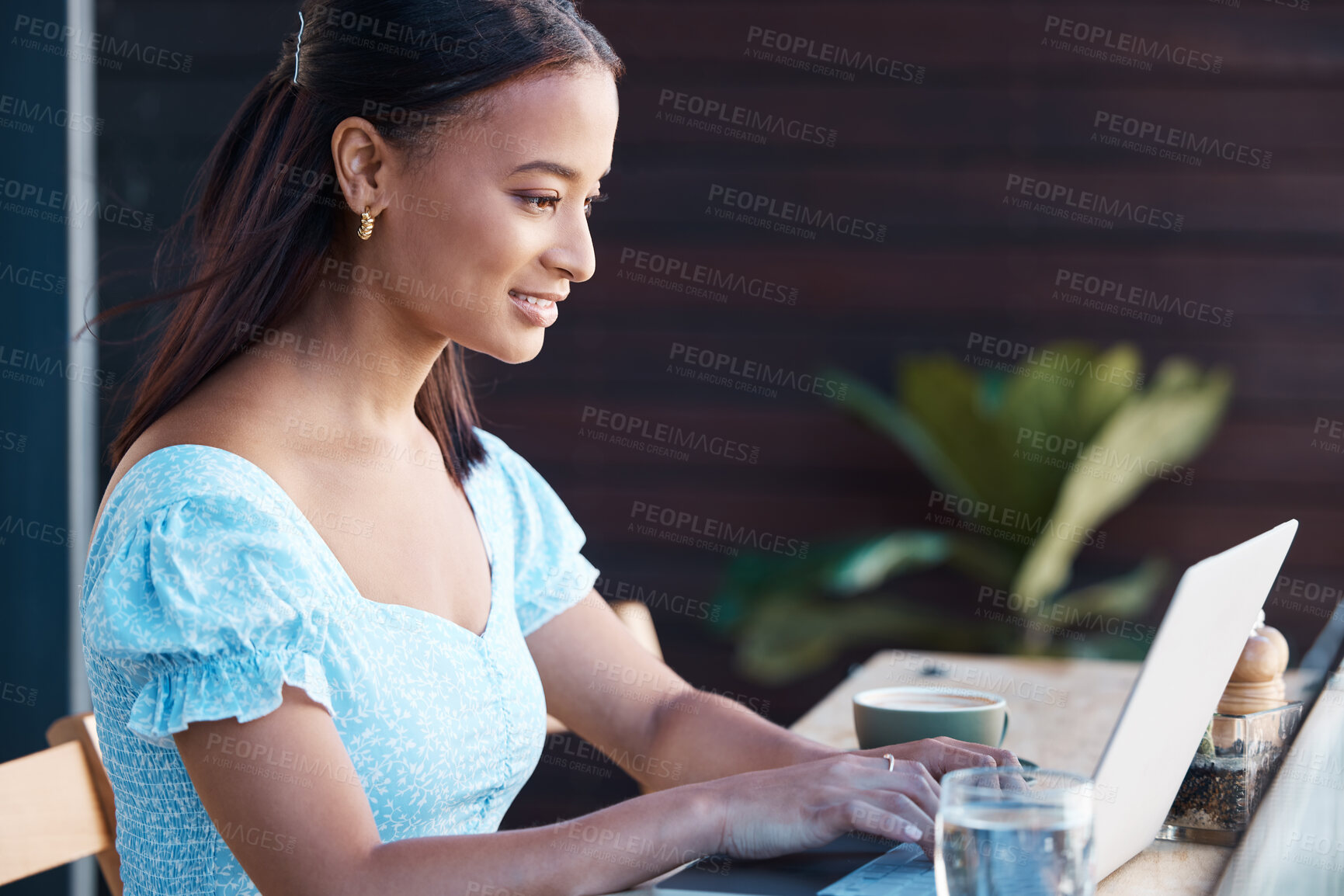 Buy stock photo Shot of a young businesswoman working at a cafe