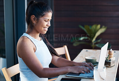 Buy stock photo Shot of a young businesswoman working at a cafe