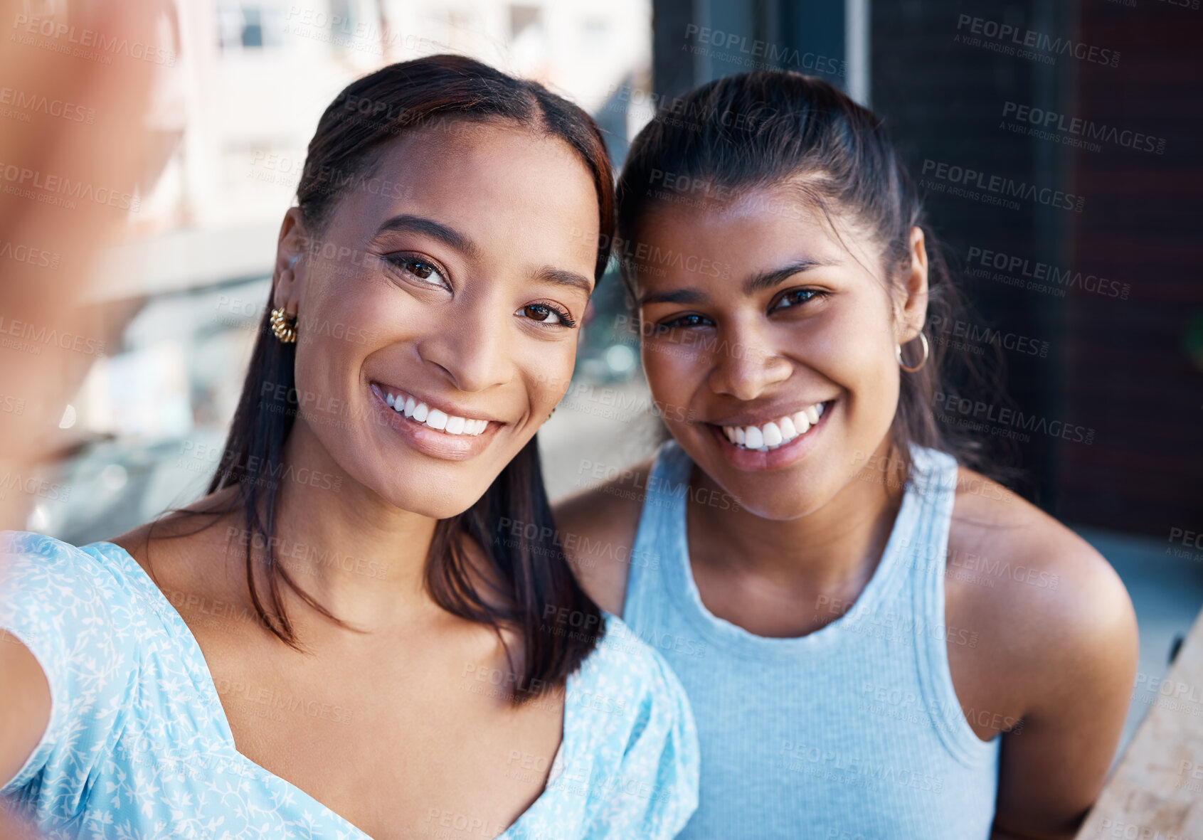 Buy stock photo Shot of two young female friends taking a selfie at a cafe