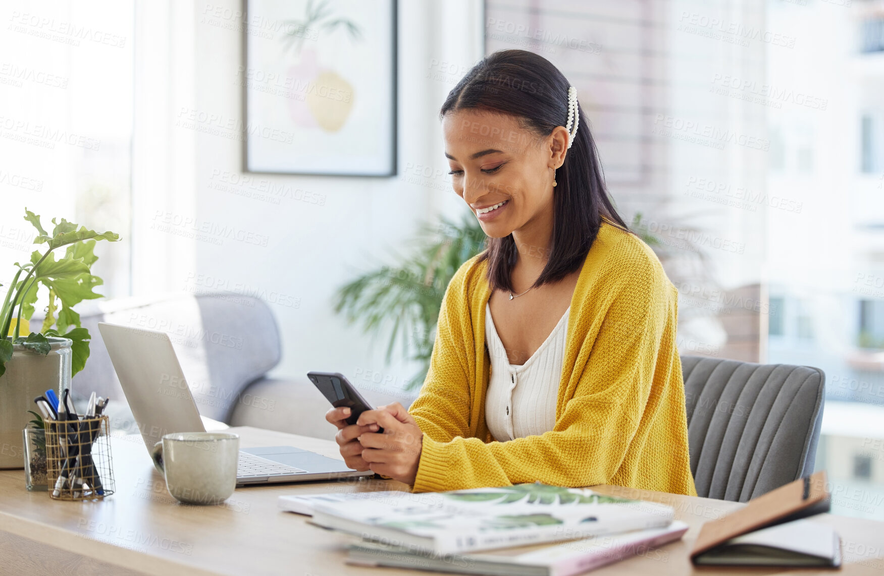 Buy stock photo Shot of a young businesswoman using a phone in a modern office at work