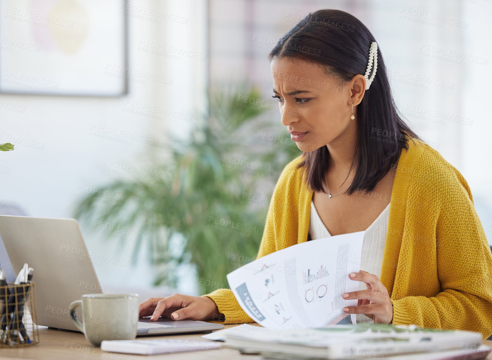 Buy stock photo Shot of a young businesswoman using a laptop in a modern office at work