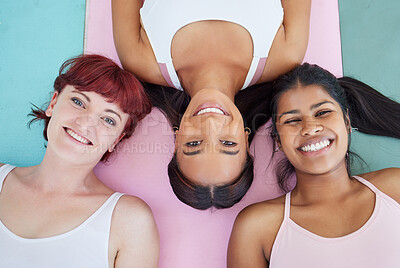 Buy stock photo High angle shot of a group of sporty women relaxing on exercise mats in a yoga studio