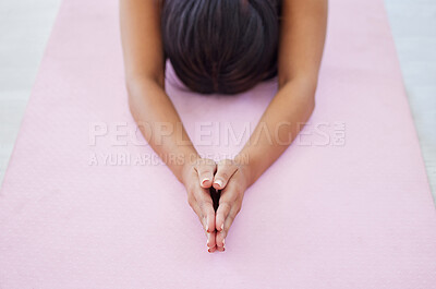 Buy stock photo Closeup shot of an unrecognisable woman doing child's pose while exercising in a yoga studio