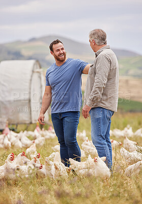 Buy stock photo Shot of two men working together on a poultry farm