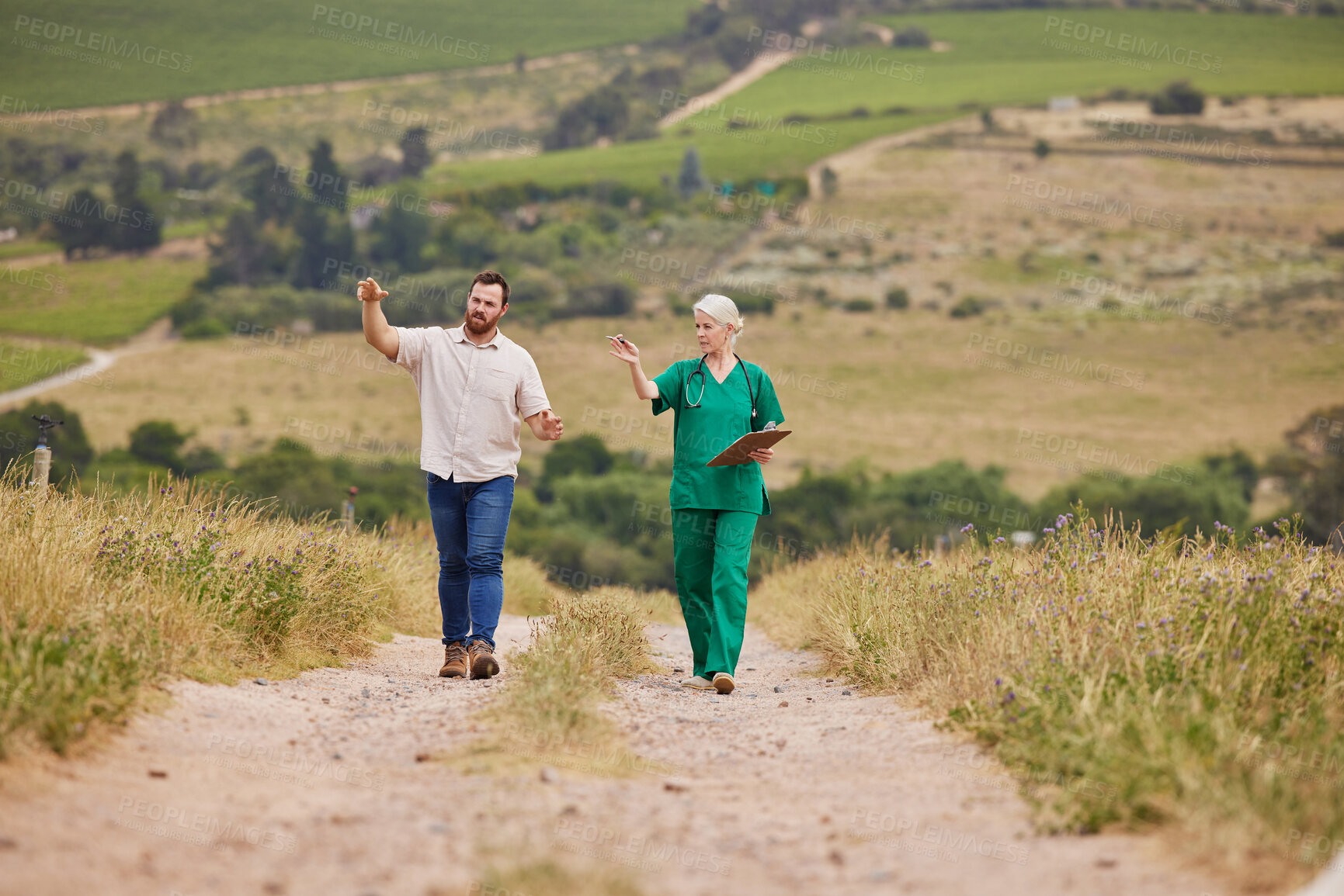 Buy stock photo Shot of a man having a discussion with a veterinarian on a poultry farm