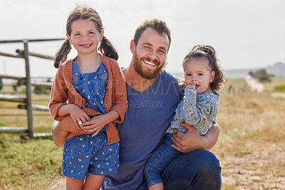 Buy stock photo Shot of a man and his two daughters spending time together on their farm