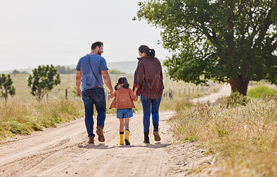Buy stock photo Shot of a little girl walking on a farm with her parents