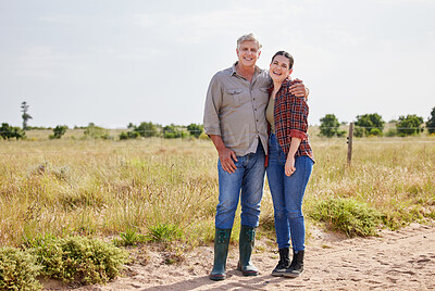 Buy stock photo Shot of a man and a woman standing together on a farm
