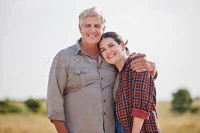 Buy stock photo Shot of a man and a woman standing together on a farm