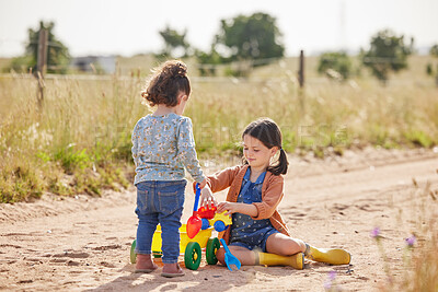 Buy stock photo Shot of two little girls playing together on a farm
