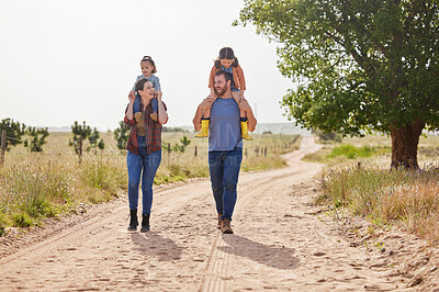 Buy stock photo Shot of a couple walking on farm with their two daughters