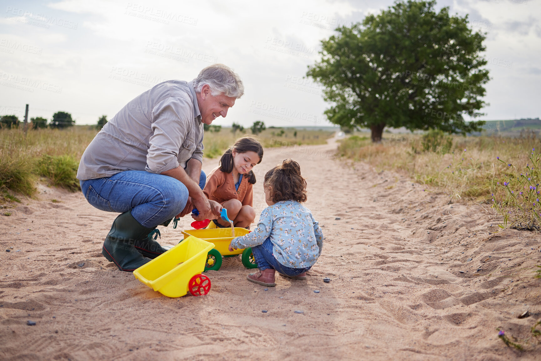 Buy stock photo Shot of two little girls playing together on a farm with their grandfather