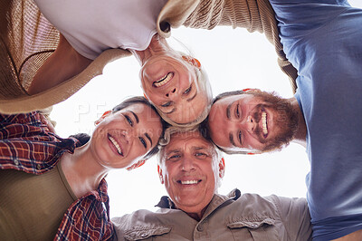 Buy stock photo Shot of a couple and their parents standing together in a huddle