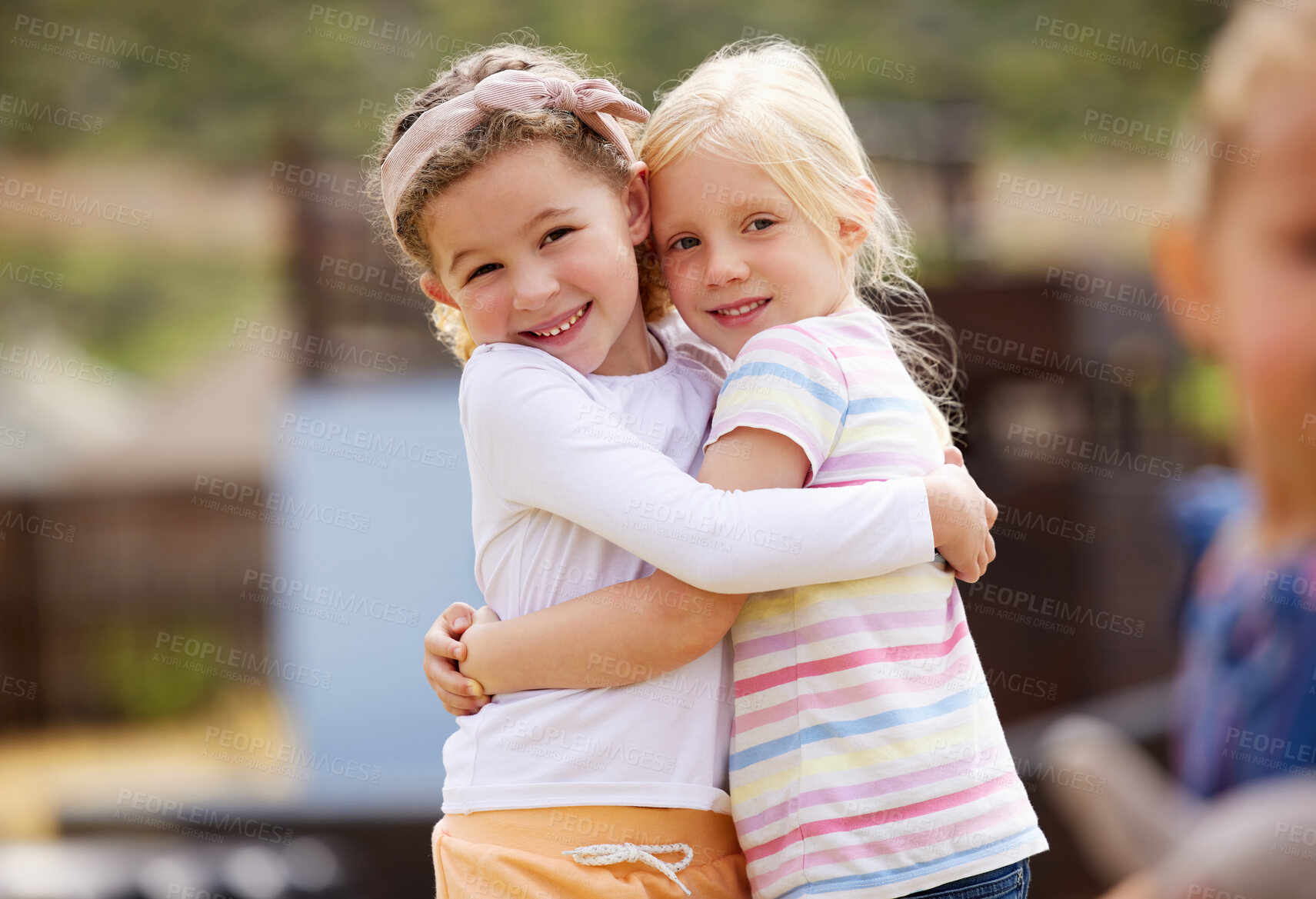 Buy stock photo Girl, friends and portrait with hug at playground for kindergarten break, recess and bonding outdoor. Students, children and playing together at montessori for development, learning support and relax