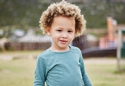 Buy stock photo Shot of an adorable little boy standing outside