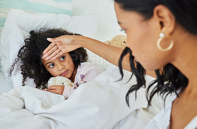 Buy stock photo Shot of a young mother looking after her sick daughter at home
