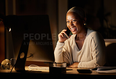 Buy stock photo Shot of a young businesswoman talking on a cellphone while working on a computer in an office at night