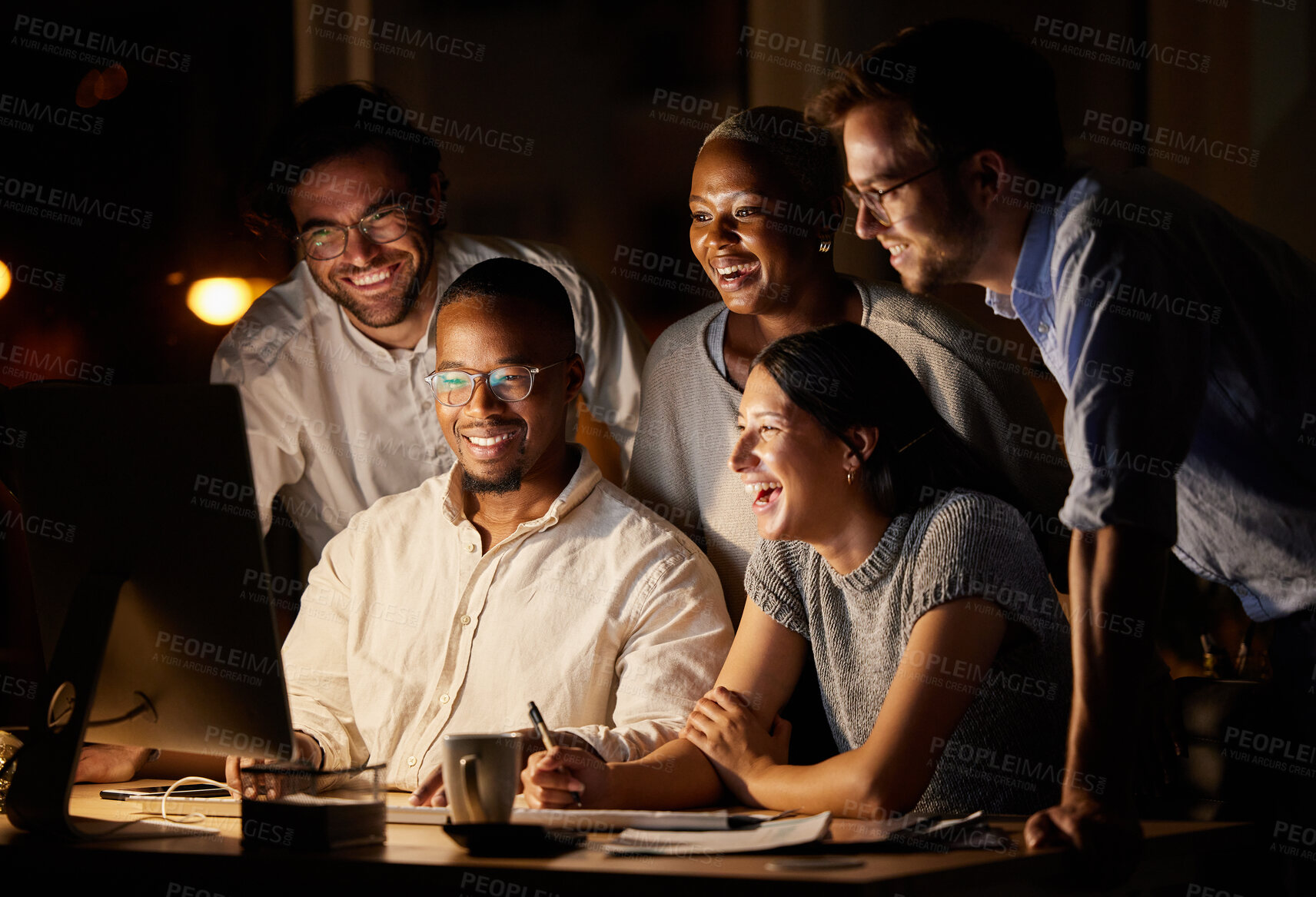 Buy stock photo Shot of a group of businesspeople working together on a computer in an office at night