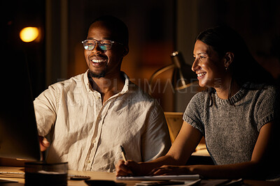 Buy stock photo Shot of two businesspeople working together on a computer in an office at night