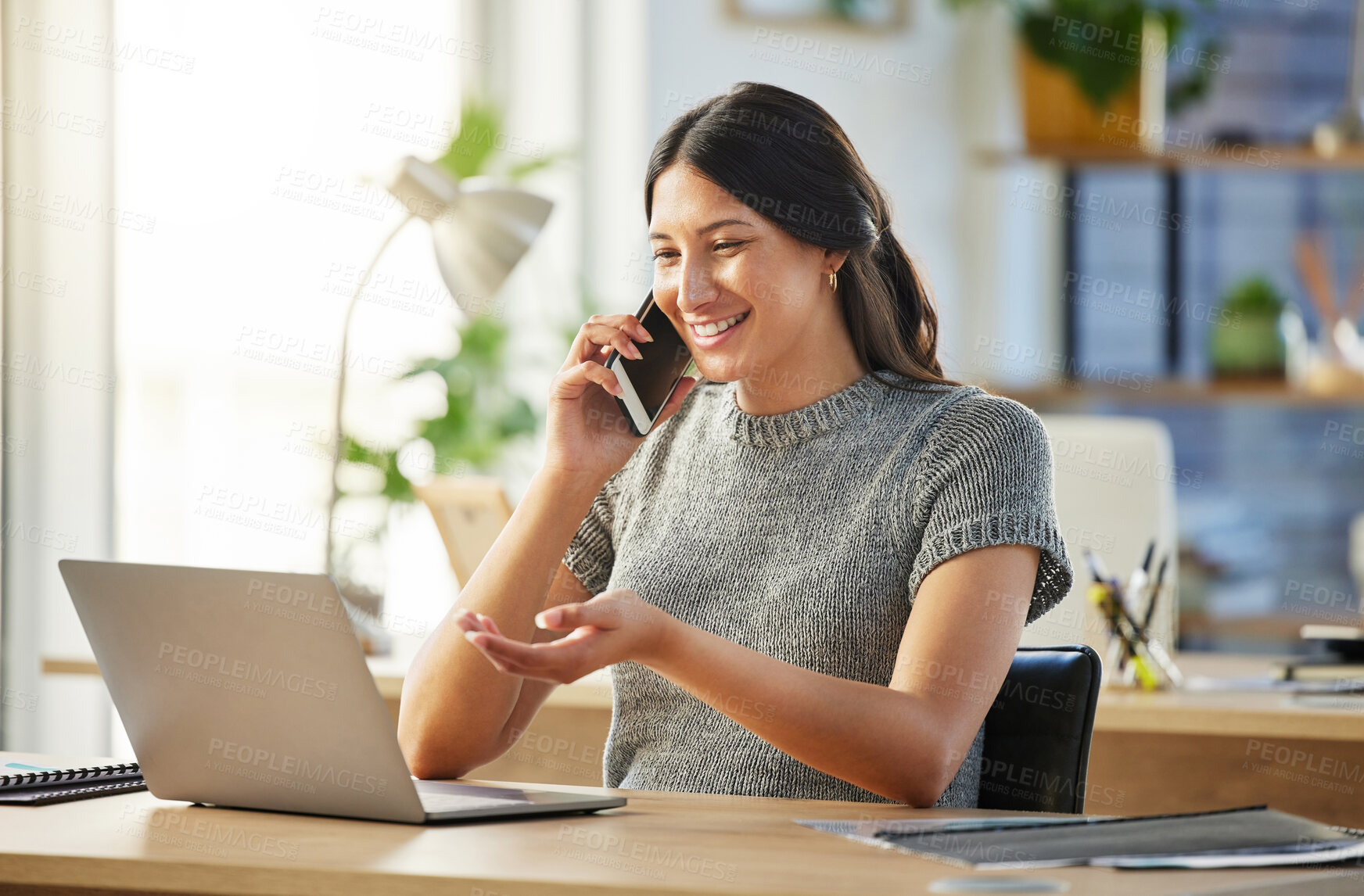 Buy stock photo Shot of a young businesswoman using her smartphone to make a phone call