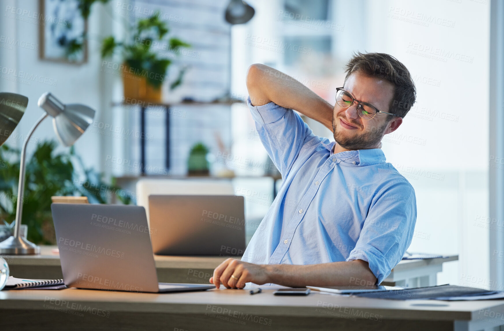 Buy stock photo Frustrated, businessman and neck injury with pain on laptop for fatigue, muscle tension or bad posture at office. Man, employee or accountant with sore back, spine or ache on computer for strain