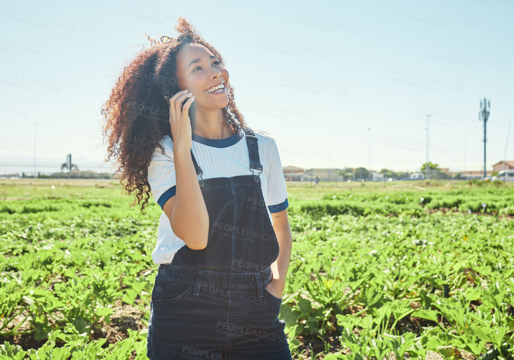 Buy stock photo Shot of a young female farmer using her phone to make a call