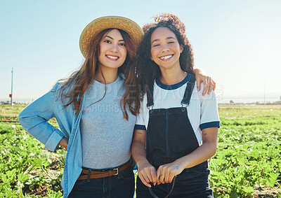 Buy stock photo Shot of two farmers hugging one another while harvesting