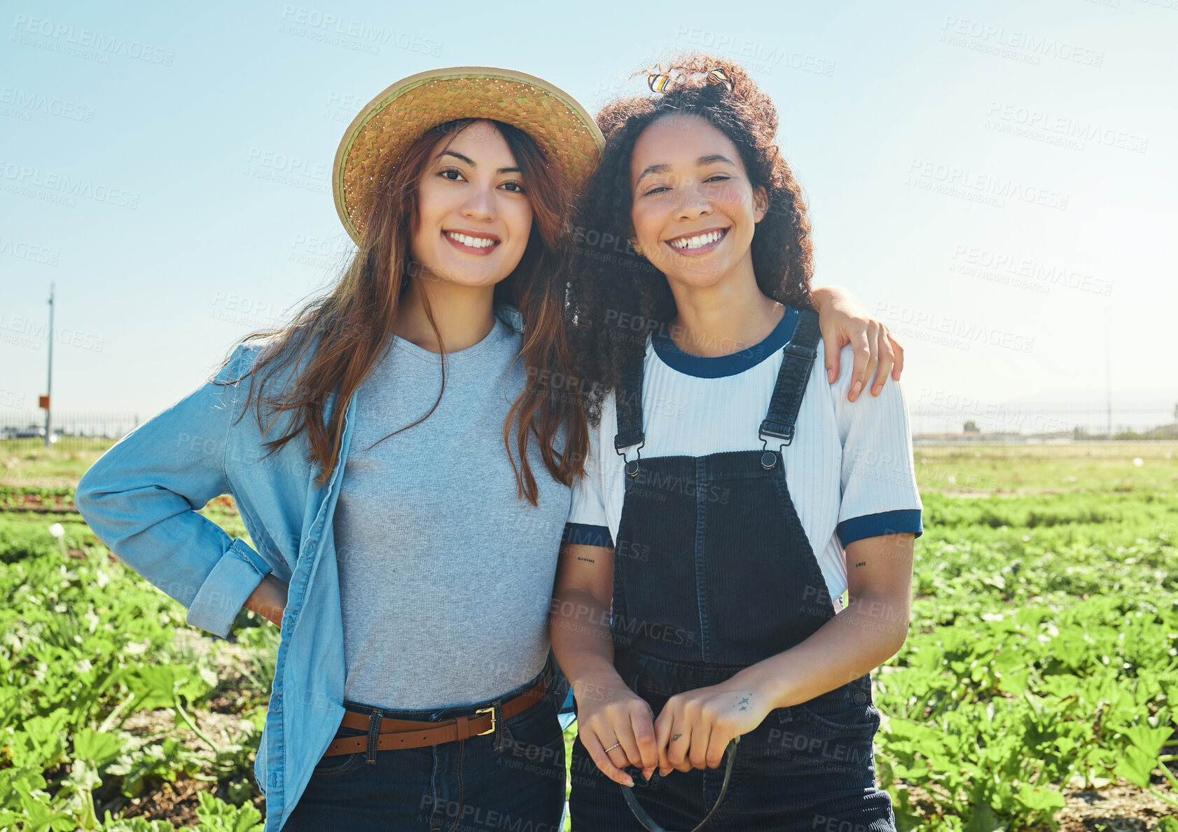 Buy stock photo Shot of two farmers hugging one another while harvesting