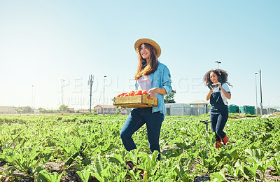 Buy stock photo Shot of two farmers walking through their crops