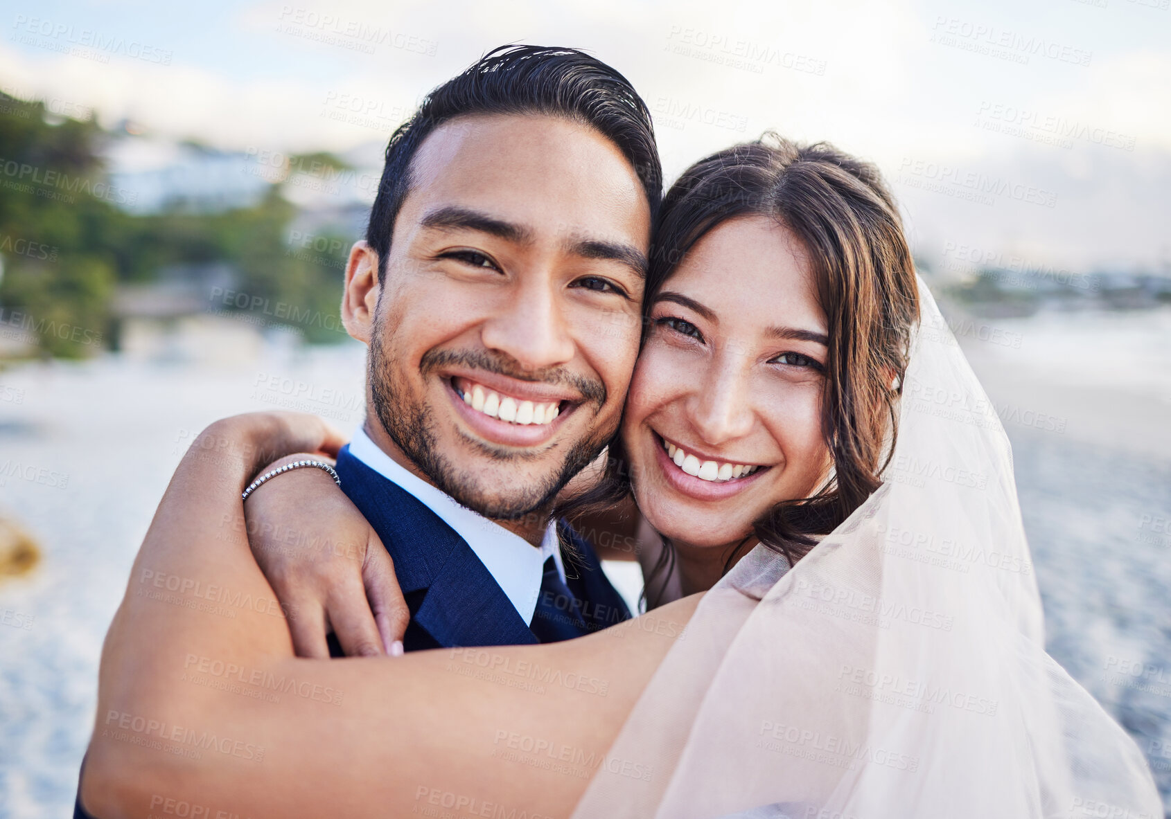 Buy stock photo Shot of a young couple on the beach on their wedding day