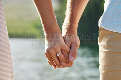 Buy stock photo Holding hands, engagement and couple at lake outdoors for love, trust and support. Commitment, care and ring jewelry of woman and man together for romance, bonding or affection with soulmate at creek