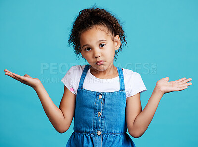 Buy stock photo Portrait, children and shrug with a girl on a blue background in studio feeling confused or lost. Kids, question and doubt with a young female child shrugging her shoulders to gesture whatever