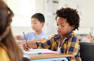 Buy stock photo Education, writing and black boy in classroom learning, exam or studying with book. Preschool, development and serious kid and student write notes in notebook, reading and knowledge in kindergarten.