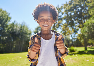 Buy stock photo Happy child, portrait or boy with thumbs up in park for a fun activity or playing in nature or summer. Excited young African kid smiling on holiday outside with success, happiness or achievement