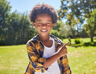 Buy stock photo African boy, pointing and park portrait with smile, happiness or playful in outdoor sunshine. Young black child, point and hand gesture on grass in summer with excited face, happy and freedom to play