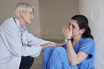 Buy stock photo Shot of a mature female doctor consoling a coworker at work