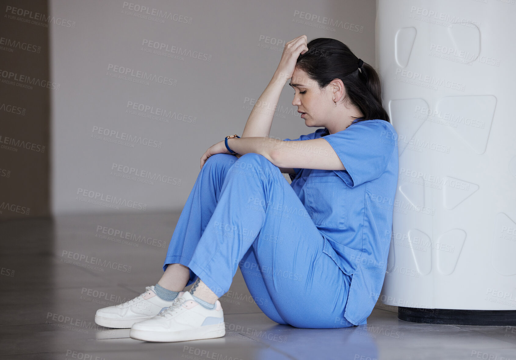 Buy stock photo Sad, doctor and stress on floor at hospital for medical mistake, depression and anxiety of healthcare burnout. Woman, relax and trauma grief for surgery news, mental health risk and emergency crisis
