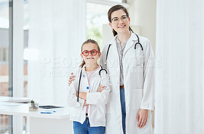 Buy stock photo Shot of a little girl standing with a doctor at a hospital