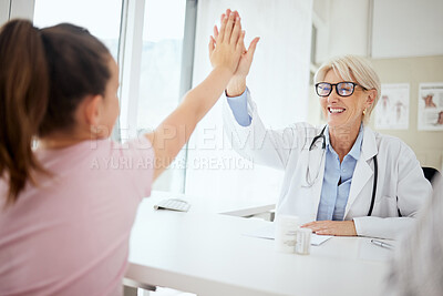 Buy stock photo Shot of a little girl giving a doctor a high five at a hospital