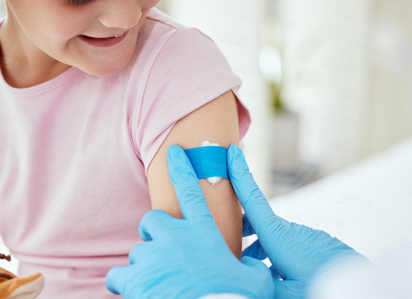 Buy stock photo Hands, girl and happy with band aid as patient at clinic for immunization or vaccine for virus. People, doctor and kid with smile on plaster for injection wound as prevention for disease and pandemic